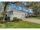 Beautifully landscaped exterior with a paved driveway and mature trees giving the home great curb appeal at 2850 Deer Run, Tarpon Springs, FL 34688