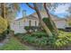 Well-maintained home exterior with manicured landscaping and mature trees at 2850 Deer Run, Tarpon Springs, FL 34688