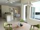 Open kitchen with a breakfast bar, white cabinetry, and views into the adjacent living spaces at 2850 Deer Run, Tarpon Springs, FL 34688
