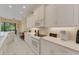 Bright kitchen featuring white cabinetry, modern appliances, and tile flooring for a clean aesthetic at 2850 Deer Run, Tarpon Springs, FL 34688