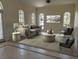 Cozy living room with neutral tones, large windows, and comfortable seating arrangement at 2850 Deer Run, Tarpon Springs, FL 34688