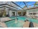 Beautiful pool area with water fountains and comfortable seating with a screened enclosure at 2850 Deer Run, Tarpon Springs, FL 34688