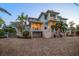 Stunning two-story beach home featuring a spacious driveway, balconies, and lush landscaping, ideal for coastal living at 477 20Th Ave, Indian Rocks Beach, FL 33785