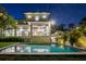 Inviting backyard pool with a modern two-story home in the background, perfect for relaxation and entertaining at 5038 W Dickens Ave, Tampa, FL 33629