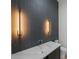Modern bathroom features a vessel sink, a gray tiled accent wall and contemporary lighting at 5038 W Dickens Ave, Tampa, FL 33629