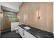 Luxurious bathroom featuring wood-look tile, glass shower, modern vanity, and sleek fixtures at 5038 W Dickens Ave, Tampa, FL 33629