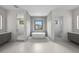 Modern bathroom featuring a soaking tub, walk-in shower, and double vanity at 5038 W Dickens Ave, Tampa, FL 33629