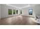 Bright bedroom with recessed lights, light wood floors, and large windows with green tree views at 5038 W Dickens Ave, Tampa, FL 33629