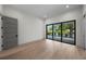 Open bedroom with hardwood floors, balcony access, recessed lighting and a gray door at 5038 W Dickens Ave, Tampa, FL 33629
