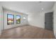Spacious bedroom with hardwood floors, three windows and gray interior door at 5038 W Dickens Ave, Tampa, FL 33629