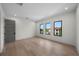Bright bedroom with hardwood floors and three windows offering neighborhood views at 5038 W Dickens Ave, Tampa, FL 33629