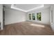 Open bedroom with hardwood floors, natural lighting, and a tray ceiling at 5038 W Dickens Ave, Tampa, FL 33629