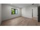 A modern bedroom with light wood floors, large windows, and recessed lighting at 5038 W Dickens Ave, Tampa, FL 33629