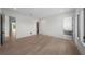 Large bedroom with hardwood floors, neutral paint, and a view into closet and bathroom at 5038 W Dickens Ave, Tampa, FL 33629