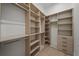 Walk-in closet boasts custom wood shelving, hanging rods, and drawers for optimal organization at 5038 W Dickens Ave, Tampa, FL 33629