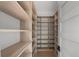 Custom walk-in closet featuring wood shelving and space for organizing clothes and accessories at 5038 W Dickens Ave, Tampa, FL 33629