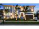 Stunning modern home featuring meticulous landscaping, stylish exterior lighting, and a sleek garage door at 5038 W Dickens Ave, Tampa, FL 33629