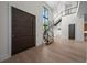 Stately foyer features a modern floating staircase, hardwood floors, and soaring ceilings at 5038 W Dickens Ave, Tampa, FL 33629