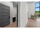 Modern hallway with sleek design, leading to laundry room and staircase with large windows at 5038 W Dickens Ave, Tampa, FL 33629
