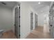 Hallway with hardwood floors and multiple doorways, creating a sense of flow at 5038 W Dickens Ave, Tampa, FL 33629