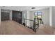 Bright hallway featuring hardwood floors, modern lighting, and metal railings, offering a stylish transition between rooms at 5038 W Dickens Ave, Tampa, FL 33629