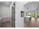 Hallway view leading to open concept kitchen and dining area, with clean lines and modern design at 5038 W Dickens Ave, Tampa, FL 33629