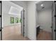 Hallway from bedroom to powder room with light wood floors, grey doors, and recessed lighting at 5038 W Dickens Ave, Tampa, FL 33629