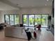 Bright living room features large windows and comfortable modern furnishings at 5038 W Dickens Ave, Tampa, FL 33629