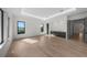 Open concept living room featuring hardwood floors, a wet bar, and tray ceiling at 5038 W Dickens Ave, Tampa, FL 33629