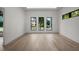 Spacious living room with bright light, hardwood floors and multiple windows at 5038 W Dickens Ave, Tampa, FL 33629
