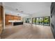 Spacious open living area features a modern kitchen, hardwood floors, and large windows at 5038 W Dickens Ave, Tampa, FL 33629