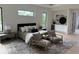 Large primary bedroom with natural light, sitting area, black trim windows and modern decor at 5038 W Dickens Ave, Tampa, FL 33629