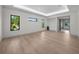 Open primary bedroom with hardwood floors, modern recessed lighting and large black trim windows at 5038 W Dickens Ave, Tampa, FL 33629