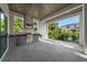 Outdoor kitchen featuring a built-in grill and countertop space under a wood ceiling at 5038 W Dickens Ave, Tampa, FL 33629