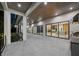Large outdoor patio features sleek tile floors, wood ceiling, and views to the kitchen and living spaces at 5038 W Dickens Ave, Tampa, FL 33629