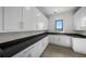 A long and wide pantry with custom cabinets, granite counters, and natural light at 5038 W Dickens Ave, Tampa, FL 33629