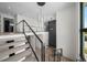 Bright foyer with modern staircase, metal railings and view to the second level featuring hardwood floors at 5038 W Dickens Ave, Tampa, FL 33629