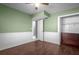 Inviting bedroom with wood floors, closet, and a ceiling fan at 705 Whiteway Dr, Brooksville, FL 34601