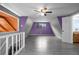 Spacious bonus room featuring gray wood-look flooring, a ceiling fan, and ample natural light at 705 Whiteway Dr, Brooksville, FL 34601