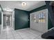 Inviting entryway boasting white tile flooring and charming double doors leading to the outside at 705 Whiteway Dr, Brooksville, FL 34601