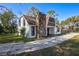 Charming two-story home boasts curb appeal with a stone chimney, and well-manicured lawn at 705 Whiteway Dr, Brooksville, FL 34601