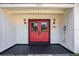 Front door, featuring sidelights, a black front porch, and a classic design at 705 Whiteway Dr, Brooksville, FL 34601
