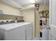 Functional laundry room featuring a washer, dryer, and water heater at 705 Whiteway Dr, Brooksville, FL 34601