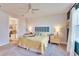 Bright bedroom with ceiling fan, carpeted floor and view of the ensuite bathroom at 12940 Brookside Moss Dr, Riverview, FL 33579