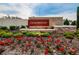 Welcoming Cedarbrook community sign amidst lush landscaping with vibrant red flowers in the foreground at 12940 Brookside Moss Dr, Riverview, FL 33579
