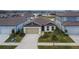 Charming single-story home featuring a two-car garage and a well-manicured front yard at 12940 Brookside Moss Dr, Riverview, FL 33579