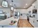 Modern kitchen with white cabinetry, stainless steel appliances, and a large center island at 12940 Brookside Moss Dr, Riverview, FL 33579