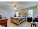 Bright main bedroom with ceiling fan, two windows, bedside tables and lamps at 16115 Country Crossing Dr, Tampa, FL 33624