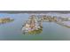 Stunning aerial view of a waterfront property featuring a pool, private dock, and beautifully landscaped grounds at 16134 4Th E St, Redington Beach, FL 33708