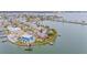 Stunning aerial view of waterfront property featuring a private pool, dock, and lush landscaping at 16134 4Th E St, Redington Beach, FL 33708